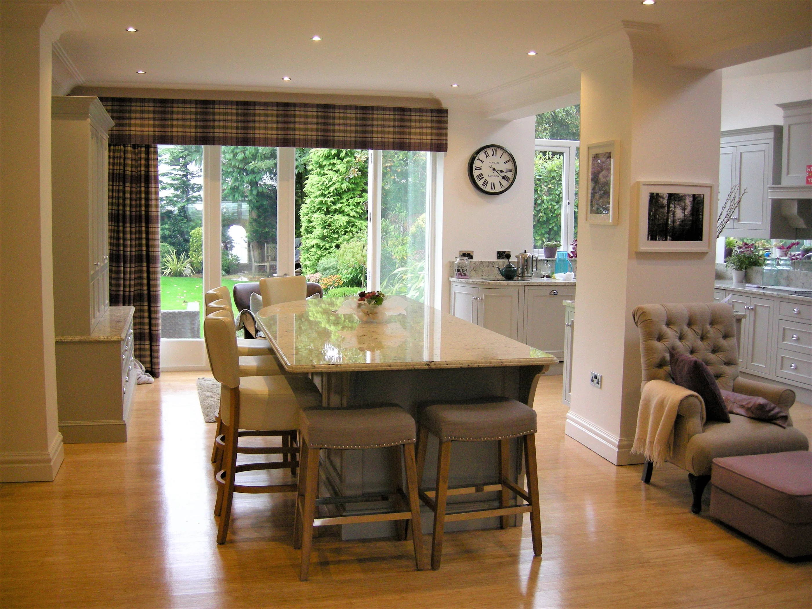 The Holman kitchen with a curved timber island in an open-plan room